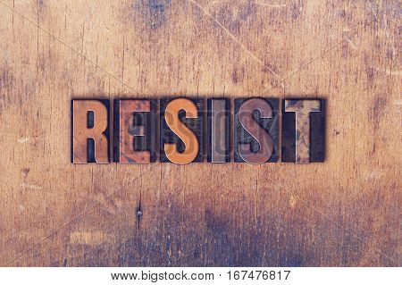 The word "RESIST" written in vintage wooden letterpress type.