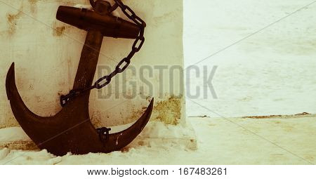 black anchor on a background of white snow retro photo