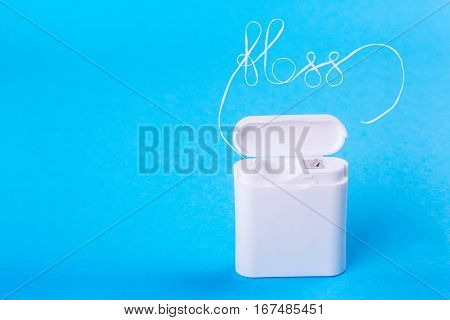 Dental floss word written in letters of floss on a blue background