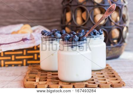 Homemade yogurt with blueberries in a glass jar