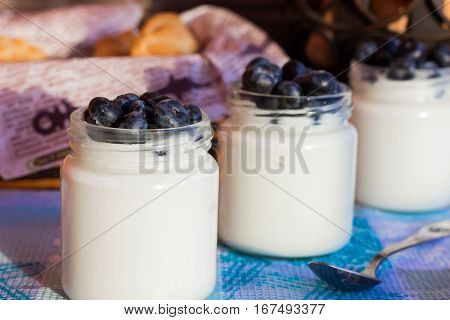 Homemade yogurt with blueberries in a glass jar
