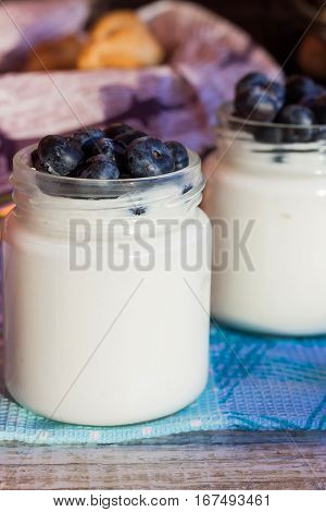 Homemade yogurt with blueberries in a glass jar