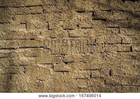 Plastered brick wall texture background. Cracked building wall. Old plastered wall surface background