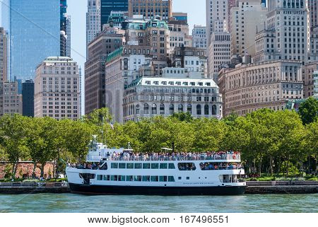 Tourist cruise ship with Manhattan buildings in the background