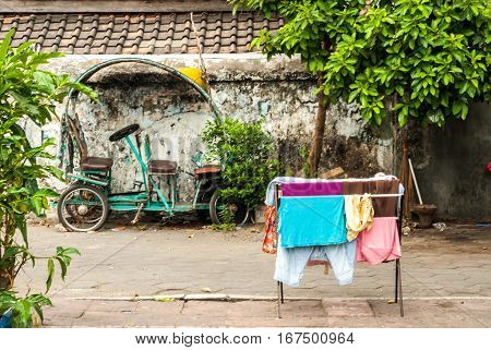 Scene behind the city walls with laundry and vehicle in Yogyakarta, Indonesia