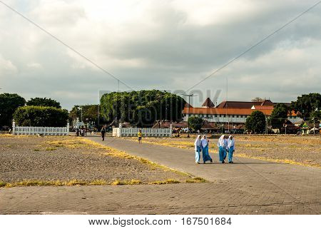 Yogyakarta, Indonesia - September 2, 2015: Young Muslimas walking in blue across Kraton square