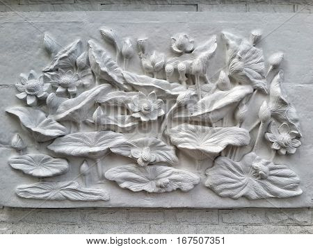 Wall bas-relief stucco in plaster depicts Lotus flowers. Bangkok Thailand