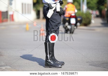 Black Boots And Traffic Pallet Of A Traffic Policeman In The Cit