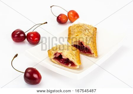 Puff pastry with fresh cherries on a white background