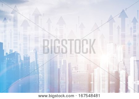 Abstract city with upward arrows and daylight. Double exposure. Finance concept