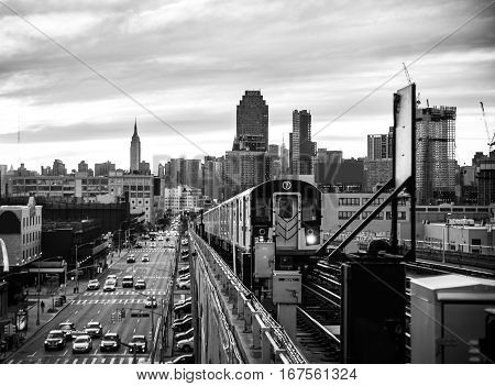 Subway train in New York at sunset and Manhattan cityscape view
