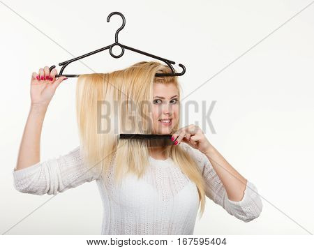 Blonde Woman Holding Hair On Clothes Hanger