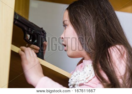 Young Girl Finds Gun In Closet