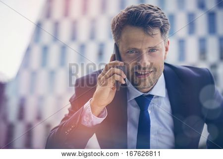Close up portrait of businessman talking on mobile phone