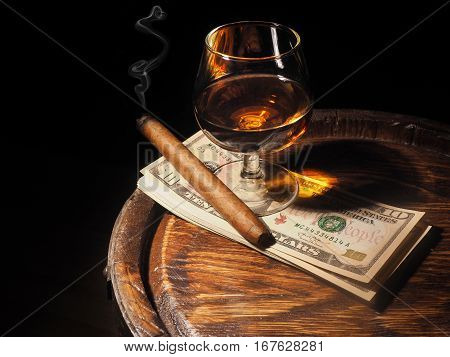 Cognac ,cigar And Dollars On Old Oak Barrel