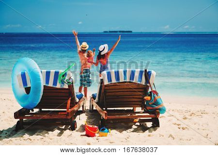 happy family with small child on tropical beach, family beach vacation