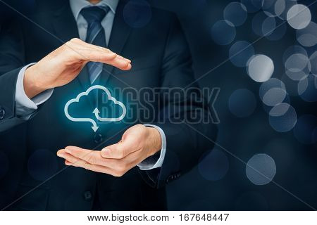 Cloud computing security concept - connect devices to cloud. Businessman or information technologist with cloud computing icon and protective gesture.