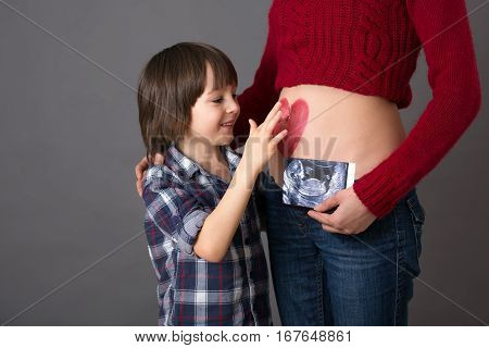 Beautiful Preschool Child, Hugging His Pregnant Mom
