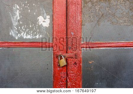 Closed old double red door with keylock