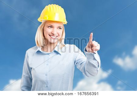 Female Engineer Wearing Helmet Using Touchscreen