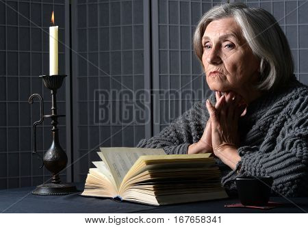 Portrait of a upset mature woman, reading book