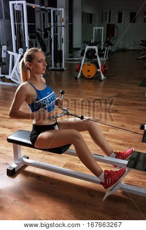 The blonde girl is engaged in a sports simulator