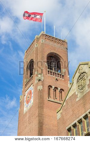 Tower Of The Berlage Building And Flag In Amsterdam