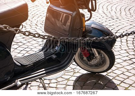 Classic motor scooter. Retro scooter on pavement. Start your engines.