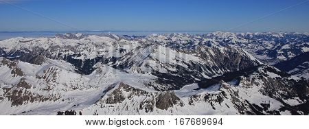 View from Glacier des Diablerets. Frozen lake Arnensee and mountains. Winter scene.