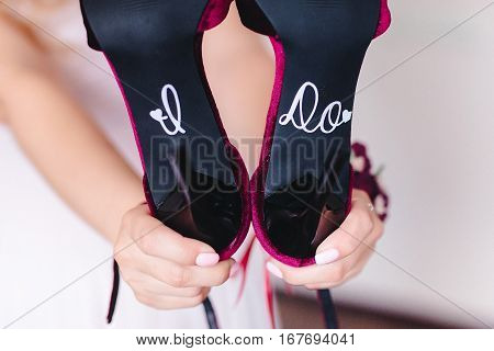 Bride fees. Beautiful wedding shoes  in the hands of the bride