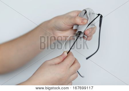 Women Hand Cleaning Glasses Lens With Isolated Background.