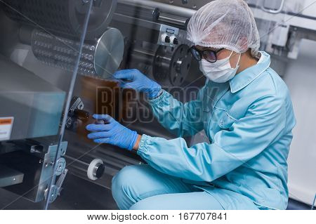 Scientist Sitting On Knees And Checking Machine