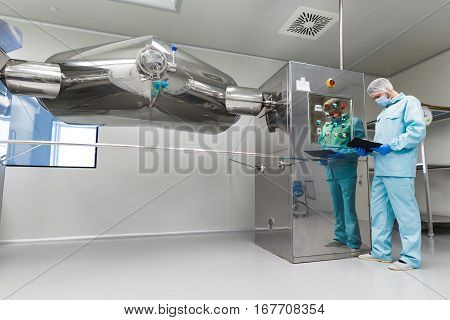 Plant Picture, Factory Worker Is Checking Control Panel On Machine