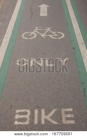 The bicycle way symbol paint on asphalt road surface