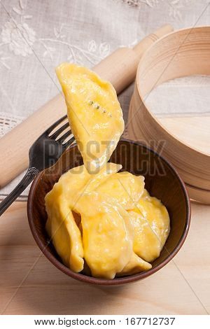 Close Up View Of Boiled Varenyky Or Dumpling With Cottage Cheese Or Curd On Metal Fork. Fresh Boiled
