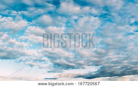 Panorama Of Bright Blue Sky With White Fluffy Clouds. Cloudy Sky. Blue Sunny Cloudscape Background