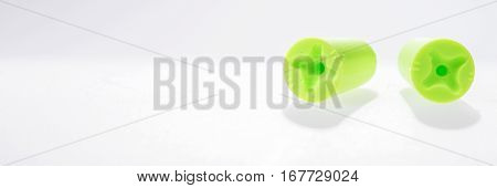 Two green ear plugs isolated on white background