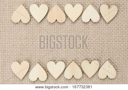 Wood hearts on hessian texture background valentine background