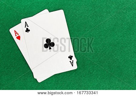 blackjack with two aces on green felt texture
