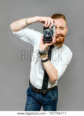 stylish the guy with the beard is photographing
