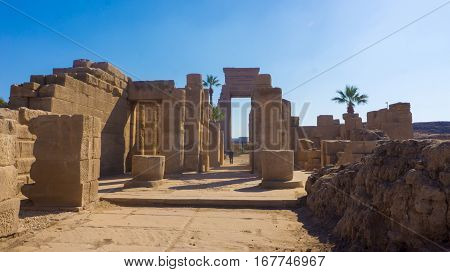 Ruins of an ancient temple of Egypt with statues and columns