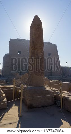 Ruins of an ancient temple of Egypt with statues and columns