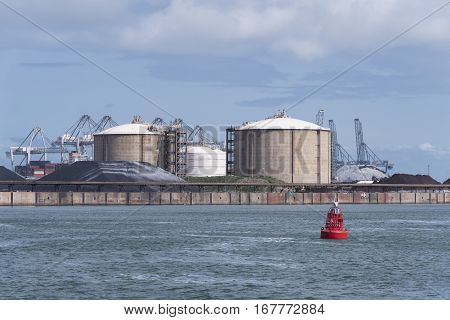 row of silos in the rotterdam bulk terminal the place for storage and transshipment of dry minerals including bauxite magnesite and bentonite.