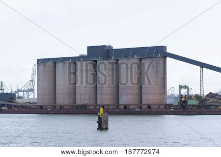row of silos in the rotterdam bulk terminal the place for storage and transshipment of dry minerals including bauxite magnesite and bentonite.