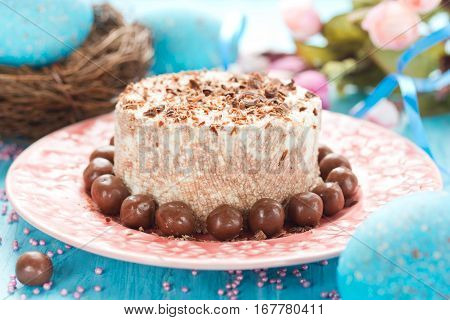 Traditional orthodox Easter dessert with cottage cheese and chocolate. Chocolate curd paskha with chocolate candy on holiday Easter table
