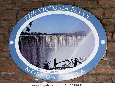 Entrance sign to The world famous Victoria Falls in Zimbabwe, also known as Mosi-oa-Tunya or The Smoke that Thunders which is a popular place for tourists to visit -  Zimbabwe, Southern Africa, October 2016
