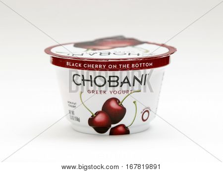 New York January 23 2017: A container of cherry Chobani greek yogurt stands against white background.