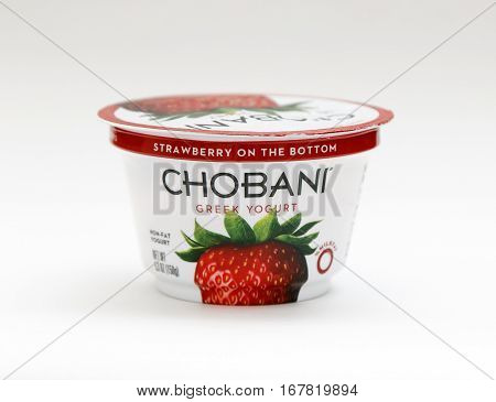 New York January 23 2017: A container of strawberry Chobani greek yogurt stands against white background.