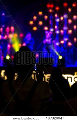 Abstract background with defocused bokeh of laser show in modern disco party night club - Concept of nightlife with music and entertainment - Image with powered colored halos and vivid bright lights