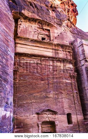 Rose Red Rock Tomb Street of Facades Petra Jordan. Built by the Nabataens in 200 BC to 400 AD. Rose Red canyon walls create many abstracts close up. Inside the Tombs the rose red can become blood red. Reds are created by magnesium in sandstone.